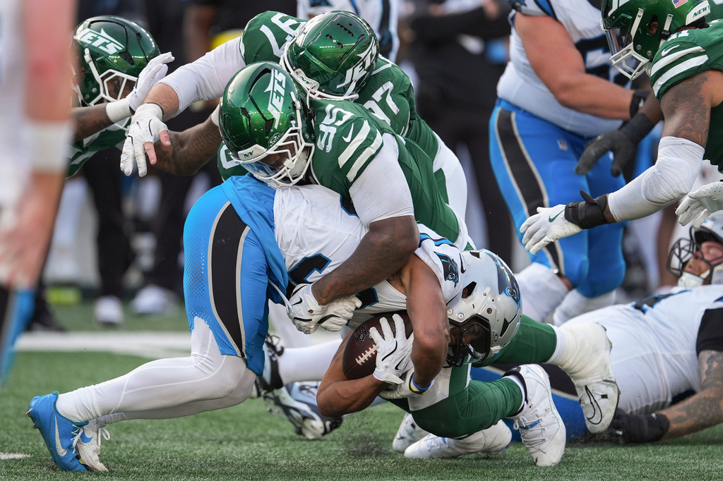 New York Jets defensive tackle Quinnen Williams (95) tackles Carolina Panthers running back Chuba Hubbard (30) during the fourth quarter of an NFL football game, Sunday, Oct. 19, 2025, in East Rutherford, N.J. (AP Photo/Seth Wenig)