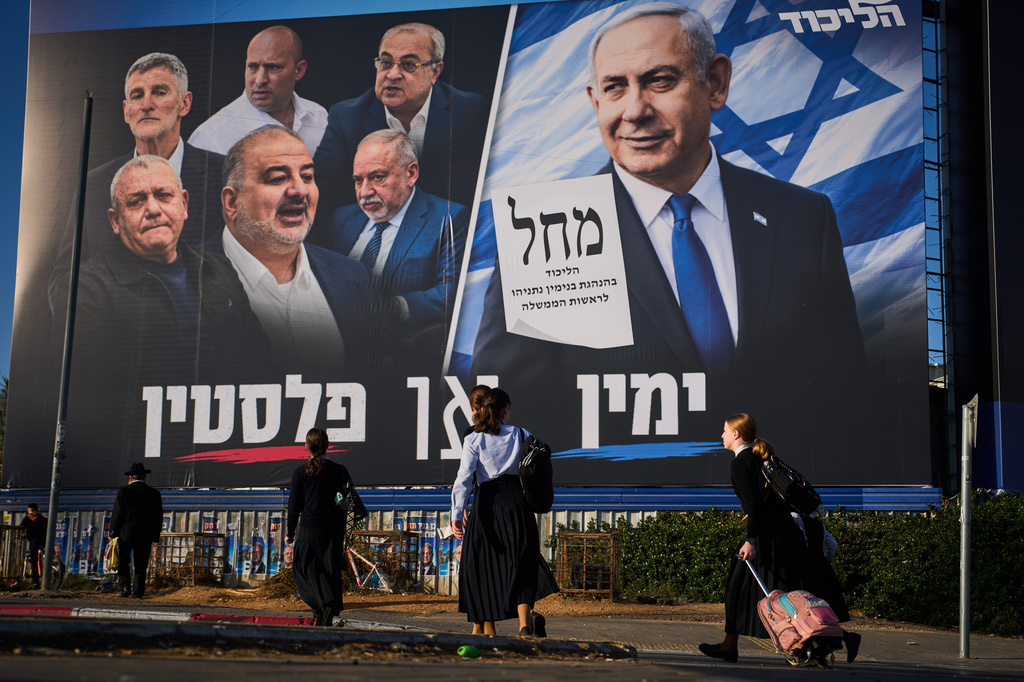 FILE - People walk past a Likud party campaign billboard featuring Israeli Prime Minister Benjamin Netanyahu alongside opposition party leaders and bearing the Hebrew slogan "Right or Palestine," ahead of Israel's general election, in Beni Brak, Israel, Sunday, Oct. 18, 2026. (AP Photo/Oded Balilty, File)