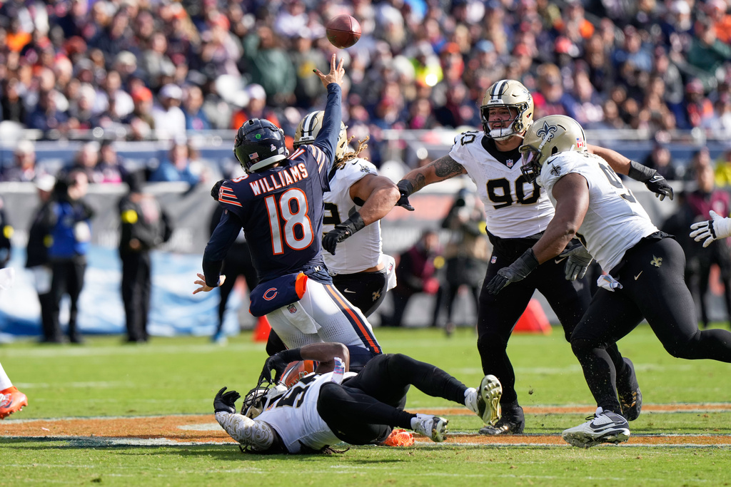 Chicago Bears quarterback Caleb Williams (18) passes under pressure in the second half of an NFL football game against the New Orleans Saints, Sunday, Oct. 19, 2025, in Chicago. (AP Photo/Nam Huh)