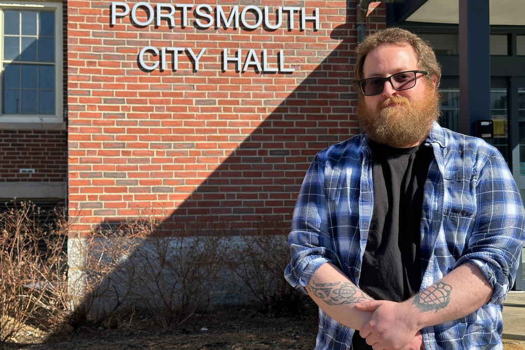 Joshua Bogdan, who faced new hurdles while registering to vote last year, poses in front of City Hall in Portsmouth, N.H., Tuesday, March 10, 2026. (AP Photo/Holly Ramer)