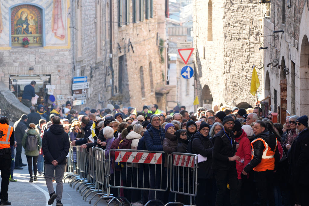 Pilgrims queue to honor the bones of St. Francis during the first public display inside the St. Francis Basilica, marking the 800th anniversary of the saint's death, in Assisi, Italy, Sunday, Feb. 22, 2026.(AP Photo/Gregorio Borgia)