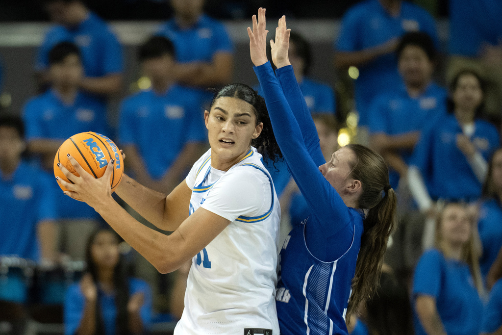 UCLA center Lauren Betts, left, posts up against UC Santa Barbara forward Olivia Bradley during the first half of an NCAA college basketball game, Thursday, Nov. 6, 2025, in Los Angeles. (AP Photo/Kyusung Gong)