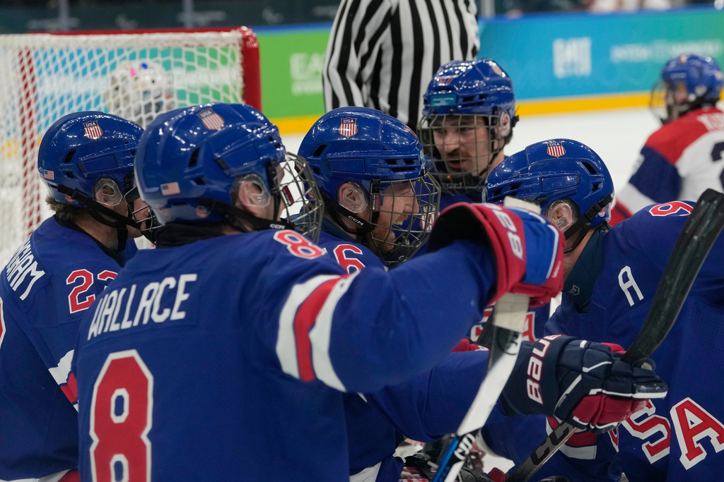 United State's Declan Farmer, center, celebrates with his teammates after scoring his side's first goal during a semifinal hockey match between United States and Czech Republic at the 2026 Winter Paralympics, in Milan, Italy, Friday, March 13, 2026. (AP Photo/Luca Bruno)