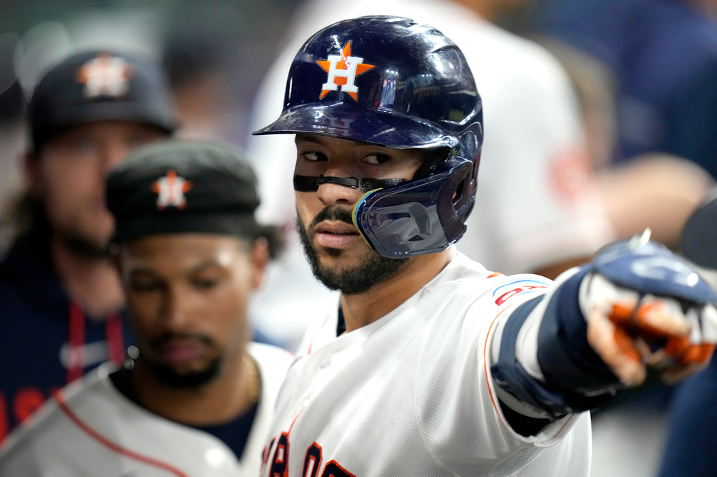 Houston Astros' Carlos Correa (1) celebrates his home run with teammates in the dugout during the sixth inning of a baseball game against the New York Yankees, Saturday, April 25, 2026, in Houston. (AP Photo/Karen Warren)