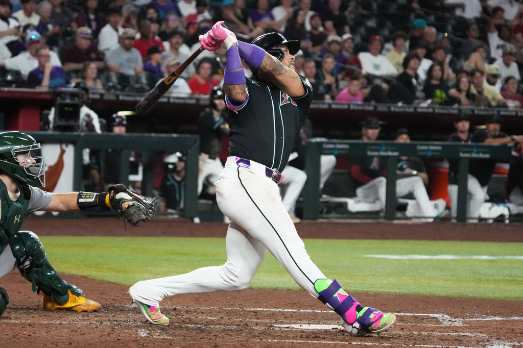 Arizona Diamondbacks' Ketel Marte hits an RBI sacrifice fly out against the Athletics in the seventh inning of a baseball game, Tuesday, July 21, 2026, in Phoenix. (AP Photo/Rick Scuteri)
