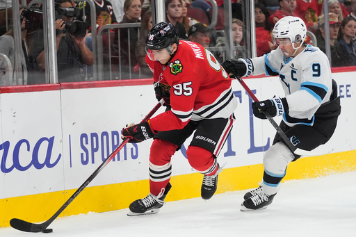 Chicago Blackhawks right wing Ilya Mikheyev, left, and Utah Mammoth right wing Clayton Keller (9) chase the puck during the second period of an NHL hockey game Monday, Oct. 13, 2025, in Chicago. (AP Photo/Erin Hooley) Chicago Blackhawks right wing Ilya Mikheyev, left, and Utah Mammoth right wing Clayton Keller (9) chase the puck during the second period of an NHL hockey game Monday, Oct. 13, 2025, in Chicago. (AP Photo/Erin Hooley)