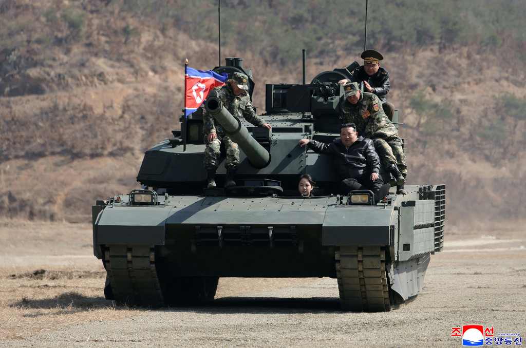 FILE - This photo provided by the North Korean government shows its leader Kim Jong Un, front right, his daughter, reportedly named Kim Ju Ae, and other soldiers on a tank at a military training base in North Korea, on March 19, 2026. Independent journalists were not given access to cover the event depicted in this image distributed by the North Korean government. The content of this image is as provided and cannot be independently verified. Korean language watermark on image as provided by source reads: "KCNA" which is the abbreviation for Korean Central News Agency. (Korean Central News Agency/Korea News Service via AP, File)