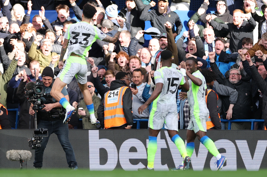 Manchester City's Nico O'Reilly celebrates after scoring during the Premier League soccer match between Chelsea and Manchester City in London, Sunday, April 12, 2026. (AP Photo/Ian Walton)