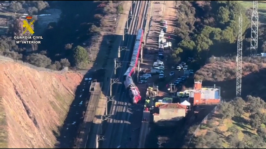 In this aerial view grab taken from video provided by Guardia Civil, a view of the Iryo train with rescue workers at the scene after a high-speed train collision, near Adamuz, Spain, Monday, Jan. 19, 2026. (Guardia Civil via AP)