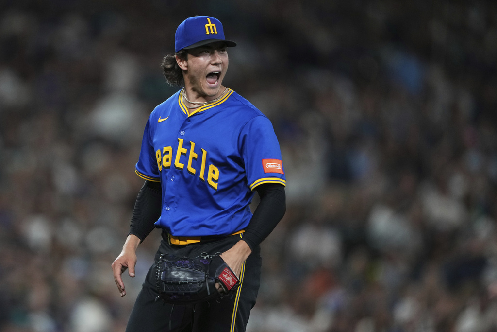 Seattle Mariners starting pitcher Bryan Woo reacts after Athletics' Lawrence Butler hit into a double play to end the top of the seventh inning of a baseball game Friday, Aug. 22, 2025, in Seattle. (AP Photo/Lindsey Wasson)