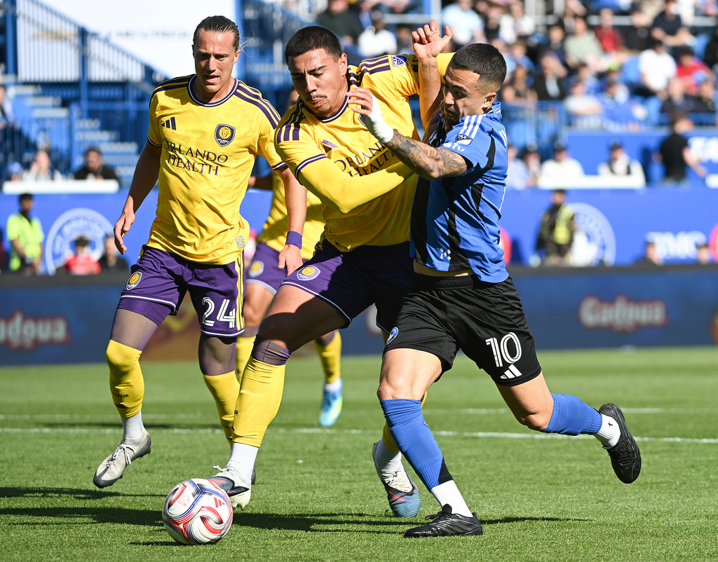CF Montreal's Ivan Jaime (10) tries to get around Orlando City's Iago Teodoro, center during first-half MLS soccer match action in Montreal, Saturday, May 9, 2026. (Graham Hughes/The Canadian Press via AP)