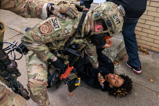 A U.S. Customs and Border Protection agent detains a protester in East Side, Chicago, Tuesday, Oct. 14, 2025. (Anthony Vazquez/Chicago Sun-Times via AP) A U.S. Customs and Border Protection agent detains a protester in East Side, Chicago, Tuesday, Oct. 14, 2025. (Anthony Vazquez/Chicago Sun-Times via AP)
