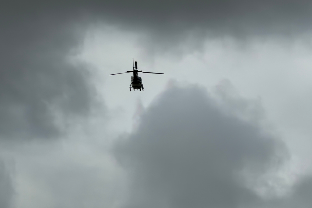 A helicopter flys over an active shooting scene Friday, June 12, 2026, in Midland, Texas. (Luke Dias/Reporter-Telegram via AP)