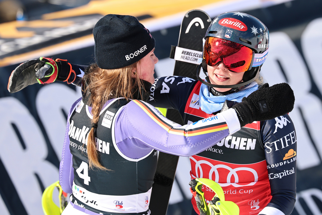 Germany's Emma Aicher, left, and United States' Mikaela Shiffrin hug each other at the finish area of an alpine ski, women's slalom race, at the Lillehammer World Cup Finals, in Hafjell, Norway, Tuesday, March 24, 2026. (AP Photo/Marco Trovati)