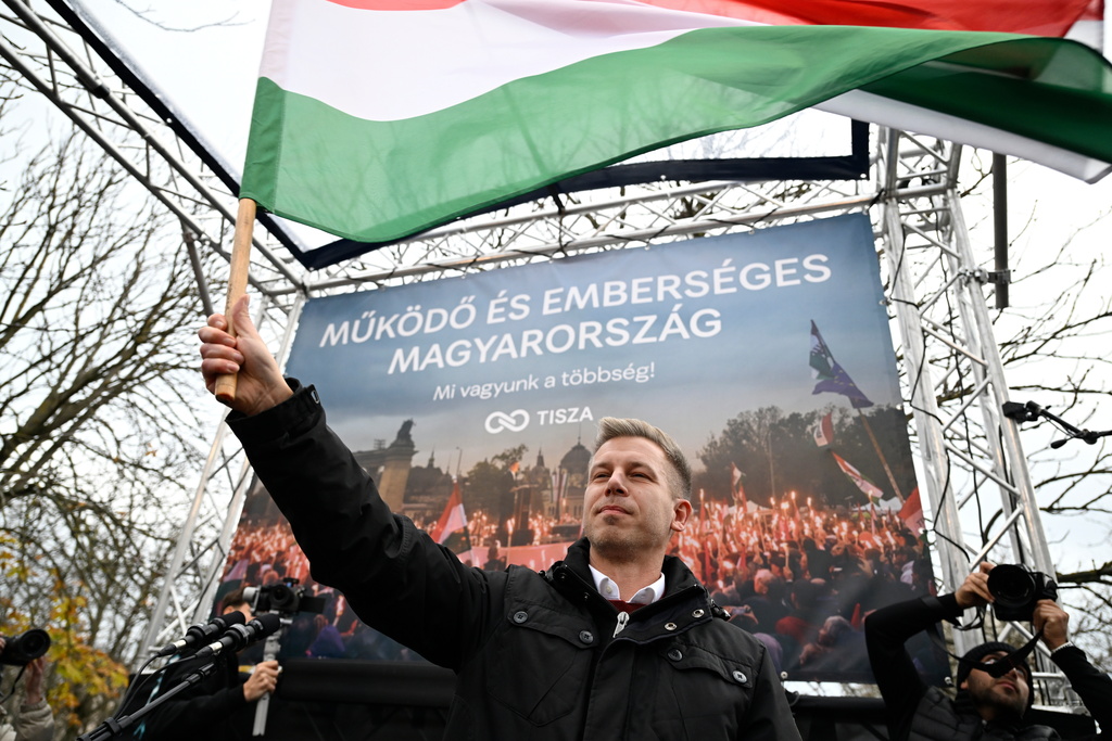 FILE - The chairman of the Hungarian opposition Tisza Party, Peter Magyar, waves a national flag during a rally in Kecskemet, Hungary, Saturday, Dec. 6, 2025. (Tamas Vasvari/MTI via AP, file)