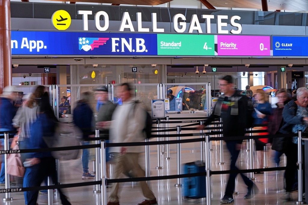 Airline travelers make their way through a TSA checkpoint queue at Pittsburgh International Airport in Imperial, Pa., Monday, March 23, 2026. (AP Photo/Gene J. Puskar)