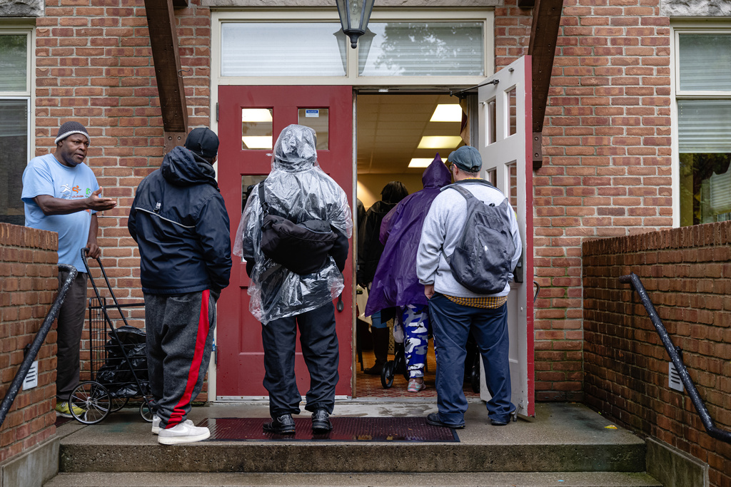 FILE - Community members wait in line to enter the food pantry service at Calvary Episcopal Church on Oct. 30, 2025, in Louisville, Ky. (AP Photo/Jon Cherry, file)