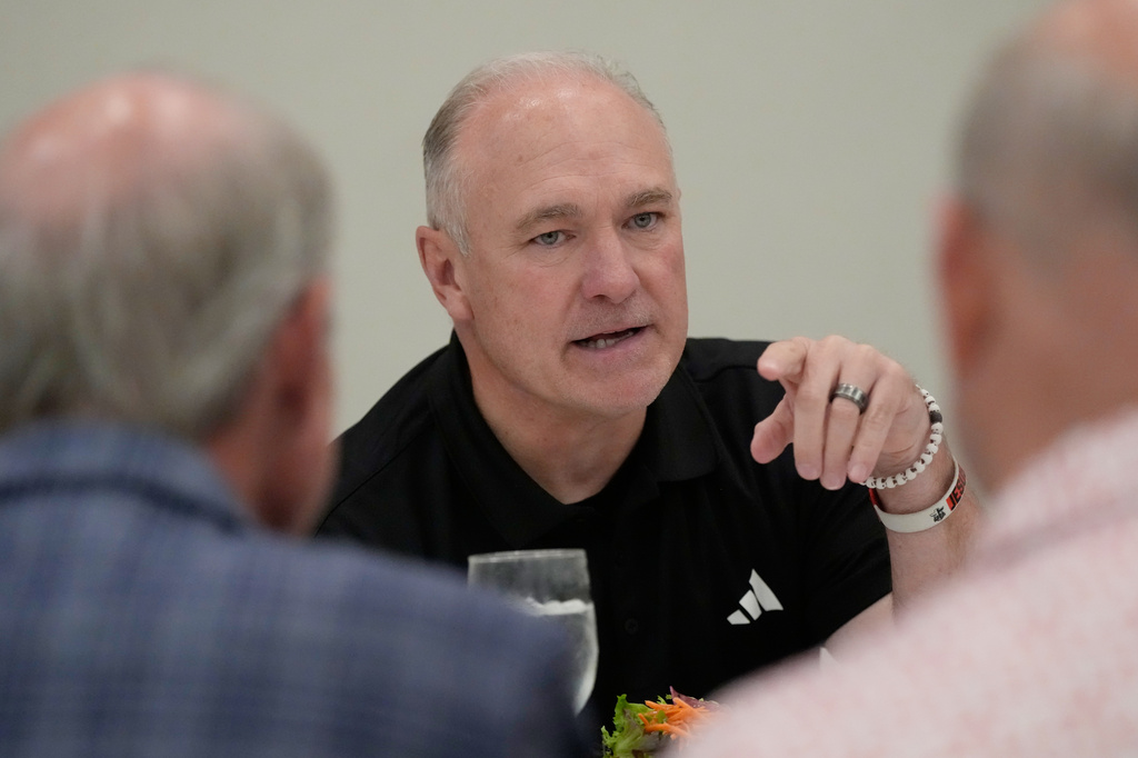 Texas Tech football coach Joey McGuire talks with attendees before speaking at The Houston Touchdown Club luncheon, Wednesday, June 10, 2026, in Houston. (AP Photo/David J. Phillip)