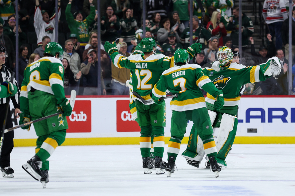 Minnesota Wild goaltender Jesper Wallstedt (30) is congratulated after the teams shootout win after an NHL hockey game against the Carolina Hurricanes Wednesday, Nov. 19, 2025, in St. Paul, Minn. (AP Photo/Matt Krohn)