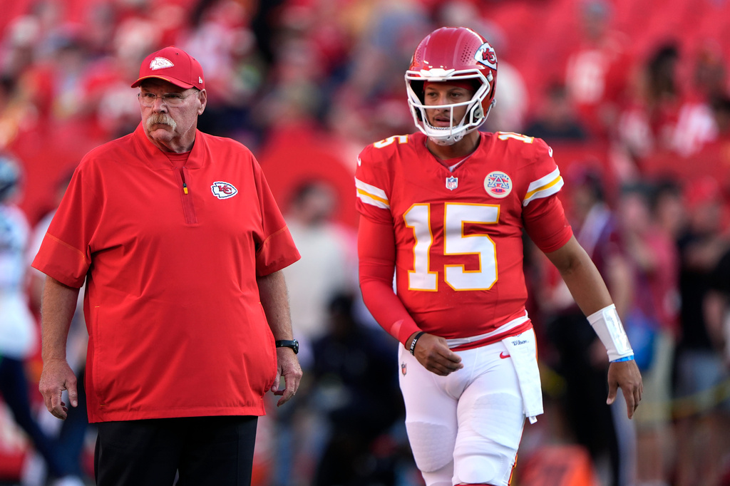 Kansas City Chiefs head coach Andy Reid, left, and Chiefs quarterback Patrick Mahomes (15) watch players warm up prior to a preseason NFL football game against the Seattle Seahawks, Friday, Aug. 28, 2026, in Kansas City, Mo. (AP Photo/Charlie Riedel)
