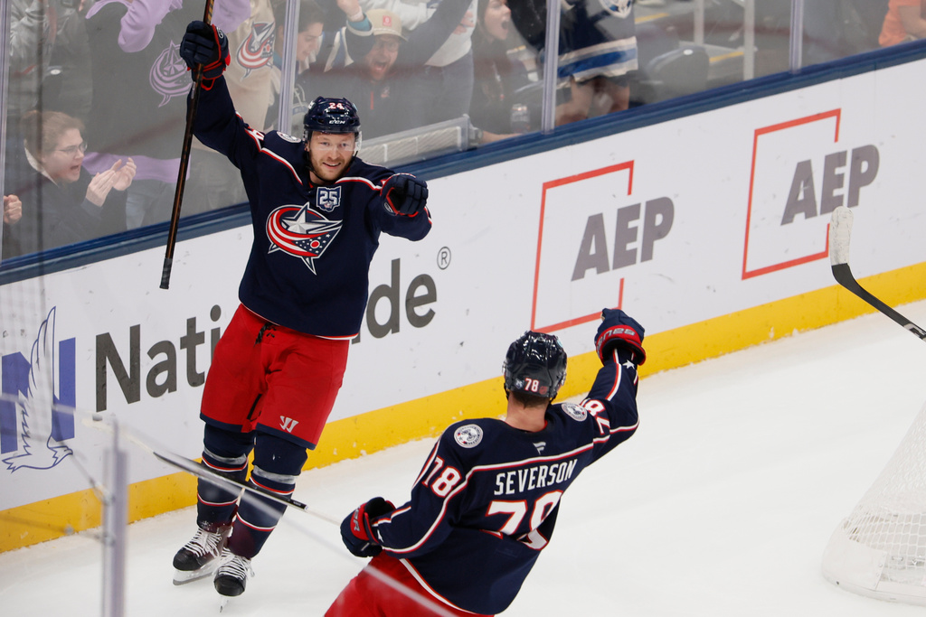 Columbus Blue Jackets' Mathieu Olivier, left, celebrates their goal against the Tampa Bay Lightning with teammate Damon Severson during the second period of an NHL hockey game, Saturday, Oct. 18, 2025, in Columbus, Ohio. (AP Photo/Jay LaPrete)