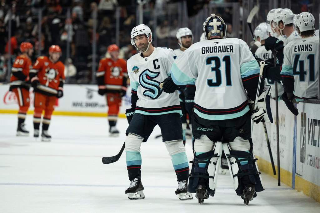 Seattle Kraken right wing Jordan Eberle (7) celebrates his goal with goaltender Philipp Grubauer (31) during the third period of an NHL hockey game against the Anaheim Ducks, Monday, Dec. 22, 2025, in Anaheim, Calif. (AP Photo/Kyusung Gong)