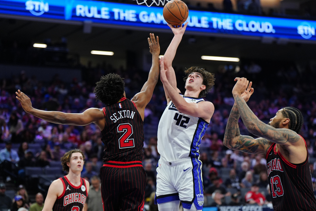 Sacramento Kings center Maxime Raynaud (42) shoots over Chicago Bulls guard Collin Sexton (2) during the first half of an NBA basketball game Sunday, March 8, 2026, in Sacramento, Calif. (AP Photo/Alan Greth)