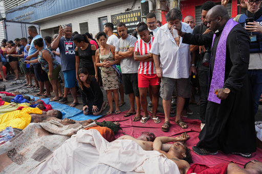 A priest blesses the bodies of people killed the day before during a police raid targeting the Comando Vermelho gang in the Complexo da Penha favela of Rio de Janeiro, Brazil, Wednesday, Oct. 29, 2025. (AP Photo/Silvia Izquierdo) A priest blesses the bodies of people killed the day before during a police raid targeting the Comando Vermelho gang in the Complexo da Penha favela of Rio de Janeiro, Brazil, Wednesday, Oct. 29, 2025. (AP Photo/Silvia Izquierdo)
