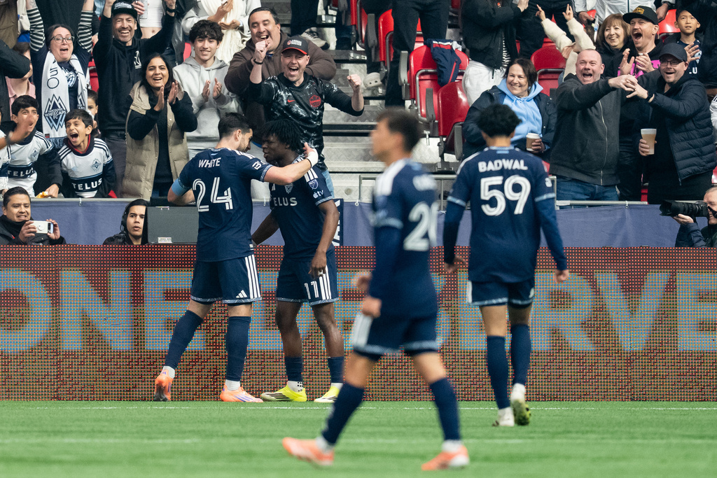 Vancouver Whitecaps' Brian White (24) celebrates his goal against Minnesota United with Emmanuel Sabbi during the first half of an MLS soccer match in Vancouver, British Columbia, Sunday, March 15, 2026. (Ethan Cairns/The Canadian Press via AP)