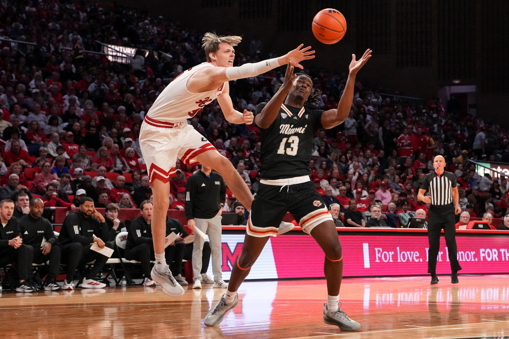 Miami (Ohio) Antwone Woolfolk (13) battles for a loose ball against Northern Illinois' Gustav Winther during the first half of an NCAA college basketball game, Saturday, Jan. 31, 2026, in Oxford, Ohio. (AP Photo/Jeff Dean)