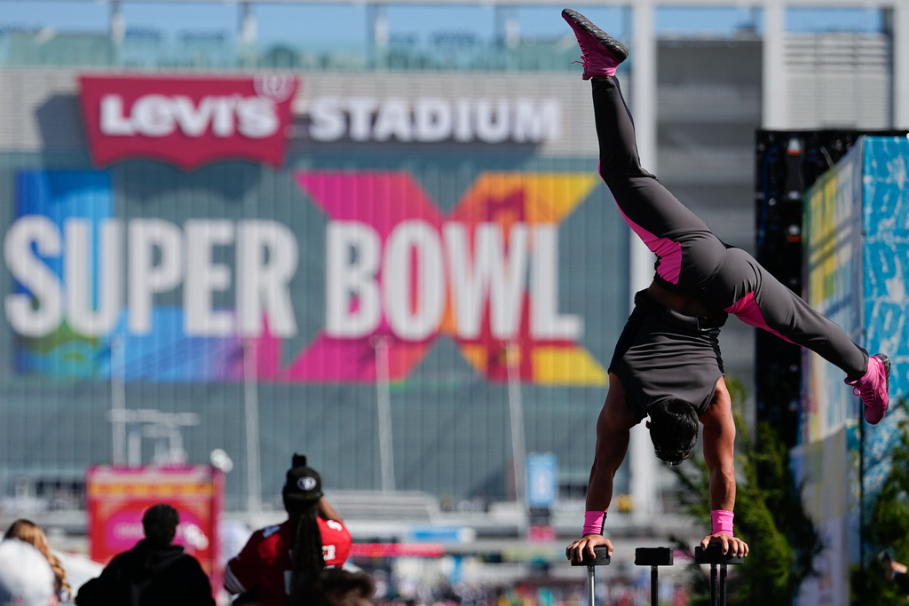 A performer balances outside Levi's Stadium before the NFL Super Bowl 60 football game between the Seattle Seahawks and the New England Patriots, Sunday, Feb. 8, 2026, in Santa Clara, Calif. (AP Photo/Julio Cortez)