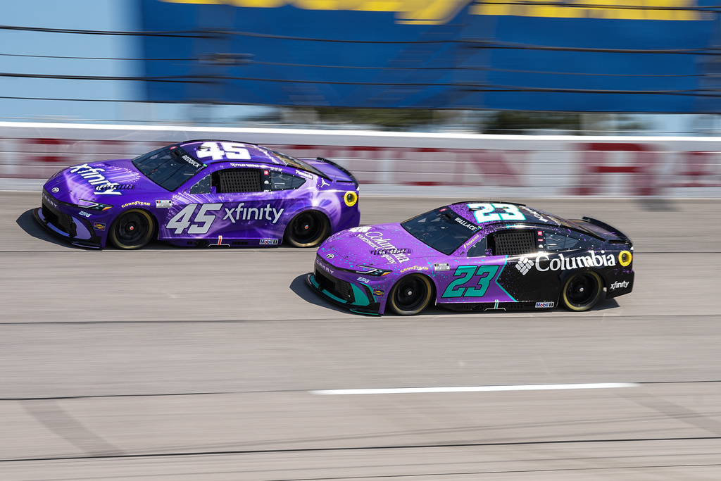 Tyler Reddick (45) and Bubba Wallace (23) compete through Turn 2 during a NASCAR Cup Series auto race, Sunday, March 22, 2026, in Darlington, S.C.(AP Photo/Matt Kelley)
