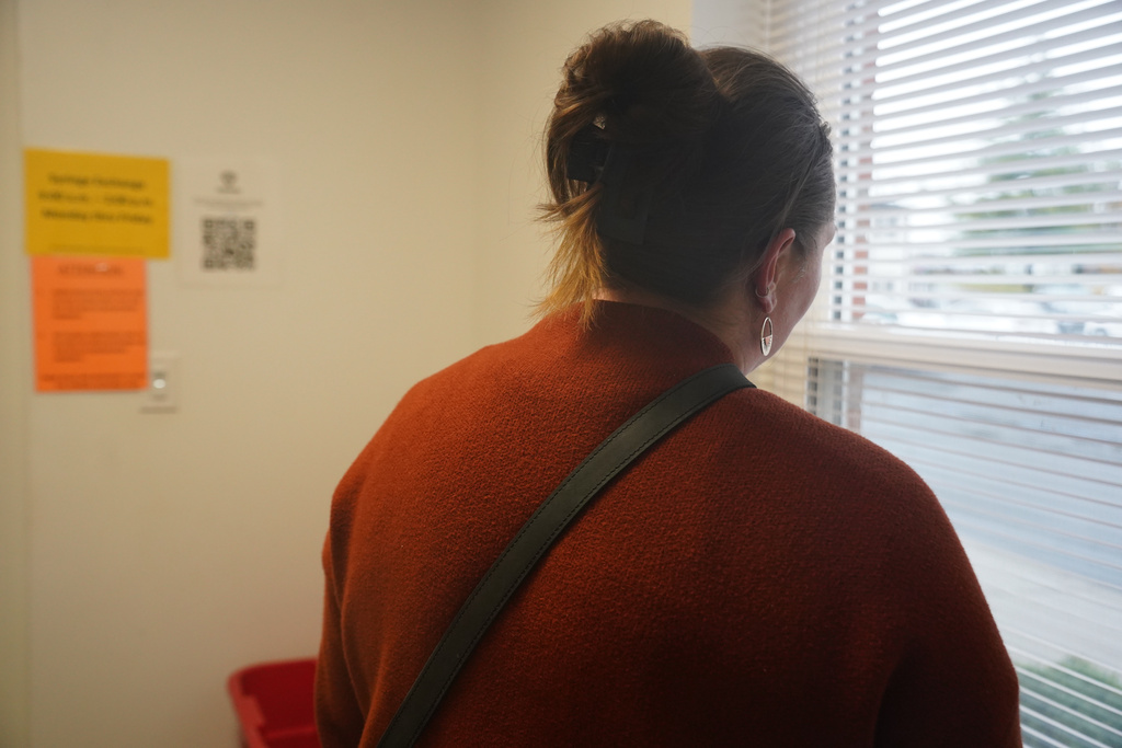 A participant in the syringe exchange program stands in an exam room at the Clark County Health Department Tuesday, Nov. 23, 2025, in Jeffersonville, Ind. (AP Photo/Obed Lamy)