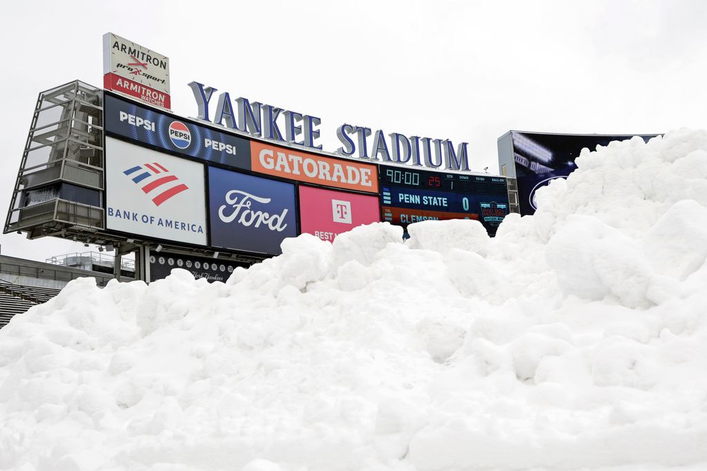 Snow is seen piled up on the field before the Pinstripe Bowl NCAA college football game between Clemson and Penn State at Yankee Stadium Saturday, Dec. 27, 2025, in New York. (AP Photo/Adam Hunger)