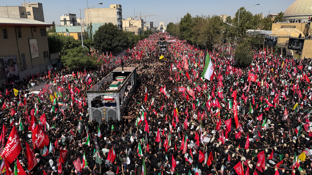 A truck carrying the coffins of the late Iranian Supreme Leader Ayatollah Ali Khamenei and members of his family makes its way through mourners during the funeral procession in Tehran, Iran, Monday, July 6, 2026. (AP Photo/Vahid Salemi)
