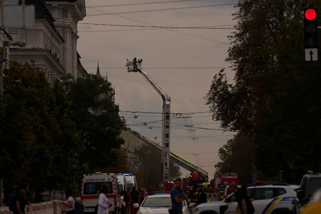 Firefighters work to extinguish a fire after a Russian drone attack struck a building in downtown Kyiv, Ukraine, Friday, Sept. 4, 2026. (AP Photo/Francisco Seco)