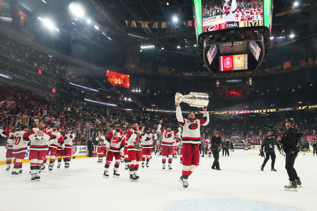 FILE - Carolina Hurricanes center Jordan Staal (11) lifts the Stanley Cup after a win over the Vegas Golden Knights in Game 6 of the NHL hockey Stanley Cup Final series, June 14, 2026, in Las Vegas. (AP Photo/Candice Ward, File)