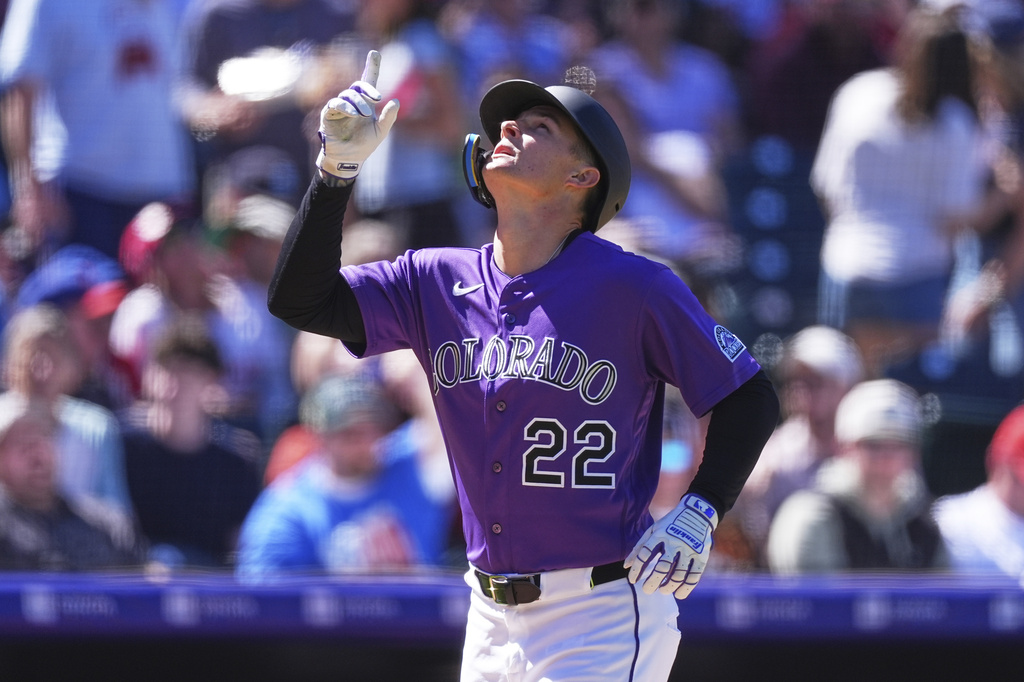 Colorado Rockies' Mickey Moniak gestures as he circles the bases after hitting a solo home run off Philadelphia Phillies starting pitcher Taijuan Walker in the fifth inning of a baseball game Sunday, April 5, 2026, in Denver. (AP Photo/David Zalubowski)