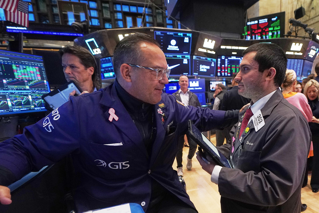 Specialist Anthony Matesic, center, and trader Drew Cohen, right, work on the floor of the New York Stock Exchange, Wednesday, Oct. 15, 2025. (AP Photo/Richard Drew)