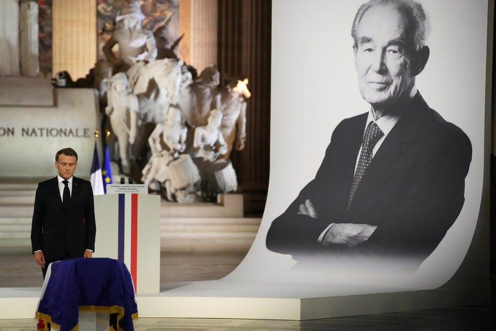 French President Emmanuel Macron pays his respects to late Robert Badinter, a revered rights defender who spearheaded France's drive to end the death penalty, during his indiction ceremony at the Pantheon monument , Thursday, Oct. 9, 2025 in Paris. (AP Photo/Christophe Ena, Pool)