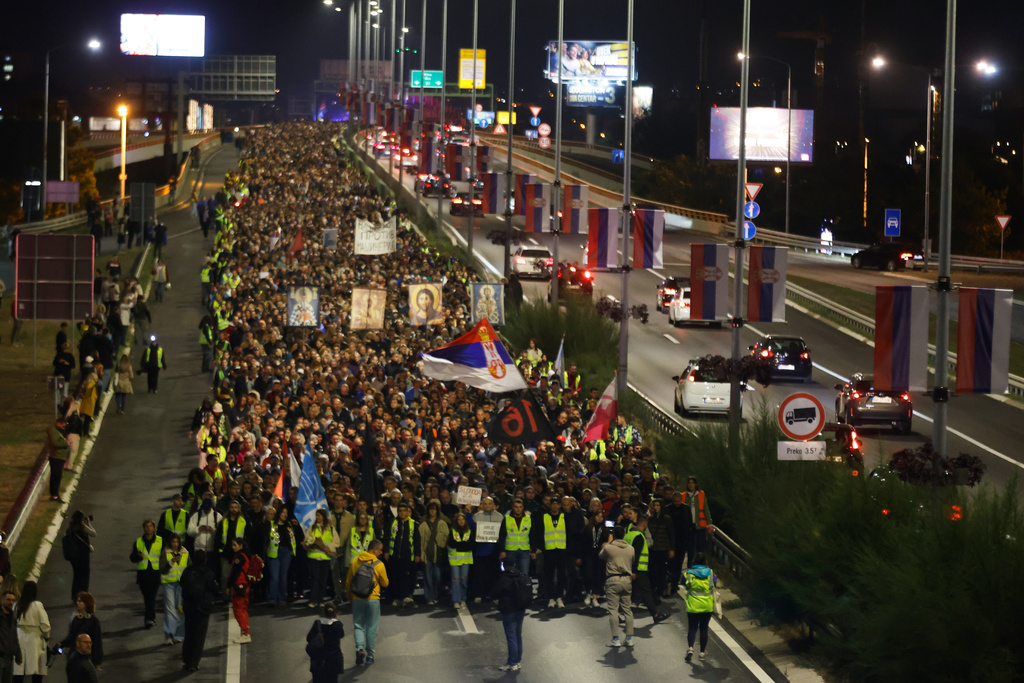 People march during a protest in Belgrade, Serbia, Wednesday, Oct. 1, 2025, eleven months after the deadly train station tragedy that sparked mass demonstrations against corruption. (AP Photo/Marko Drobnjakovic)