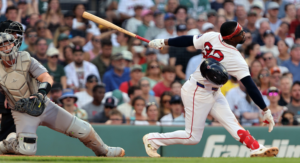Boston Red Sox shortstop Andruw Monasterio loses his helmet as he strikes out in the eighth inning of a baseball game against the Athletics, Saturday, Aug. 8, 2026 in Boston. (AP Photo/Jim Davis)
