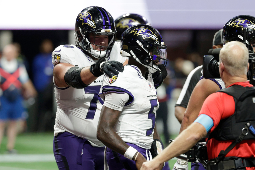 Baltimore Ravens quarterback Tyler Huntley (5) celebrates with teammates after a touchdown run during overtime in a NFL football game against the Atlanta Falcons, Sunday, Oct. 11, 2026, in Atlanta. (AP Photo/Erik S. Lesser)