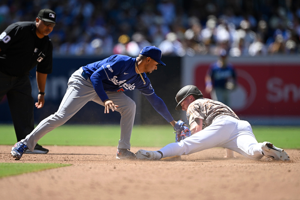 San Diego Padres' Jackson Merrill (3) steals second base ahead of the tag of Los Angeles Dodgers shortstop Mookie Betts (50) during the sixth inning of a baseball game, Sunday, June 28, 2026, in San Diego. (AP Photo/Denis Poroy)