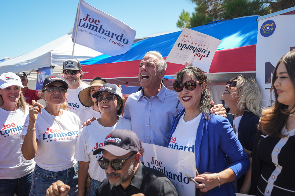 Nevada Gov. Joe Lombardo, center, poses with supporters outside a vote center Tuesday, June 9, 2026, in Las Vegas. (AP Photo/Jae C. Hong)