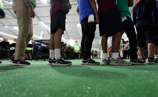 FILE - Immigrants line up in the dining hall at a new U.S. government holding center for migrant children in Carrizo Springs, Texas, on July 9, 2019. (AP Photo/Eric Gay, File) FILE - Immigrants line up in the dining hall at a new U.S. government holding center for migrant children in Carrizo Springs, Texas, on July 9, 2019. (AP Photo/Eric Gay, File)