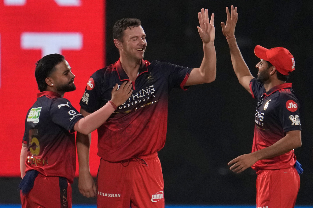 Royal Challengers Bengaluru's Josh Hazlewood, center, celebrate with teammates the wicket of Delhi Capitals' Sameer Rizvi during the Indian Premier League cricket match between Delhi Capitals and Royal Challengers Bengaluru in Delhi, India, Monday, April 27, 2026. (AP Photo/Manish Swarup)