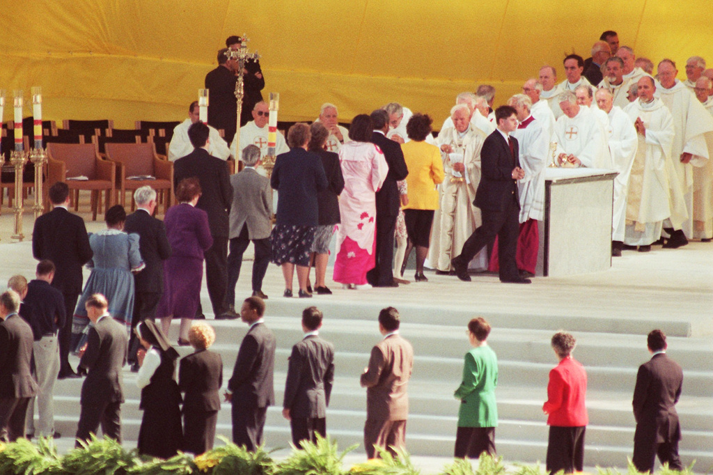 FILE - People line up to receive communion from Pope John Paul II as he celebrates mass at Aqueduct Raceway in the Queens borough of New York, Oct. 6, 1995. (AP Photo/Mark Lennihan, File)