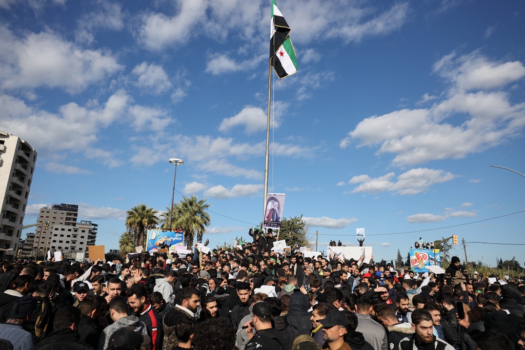 Protesters from the Alawite religious minority demonstrate two days after a bomb in an Alawite mosque in Homs killed eight people and wounded 18 during Friday prayers, in Latakia, Syria's coastal region, Sunday, Dec. 28, 2025. (AP Photo/Omar Albam)