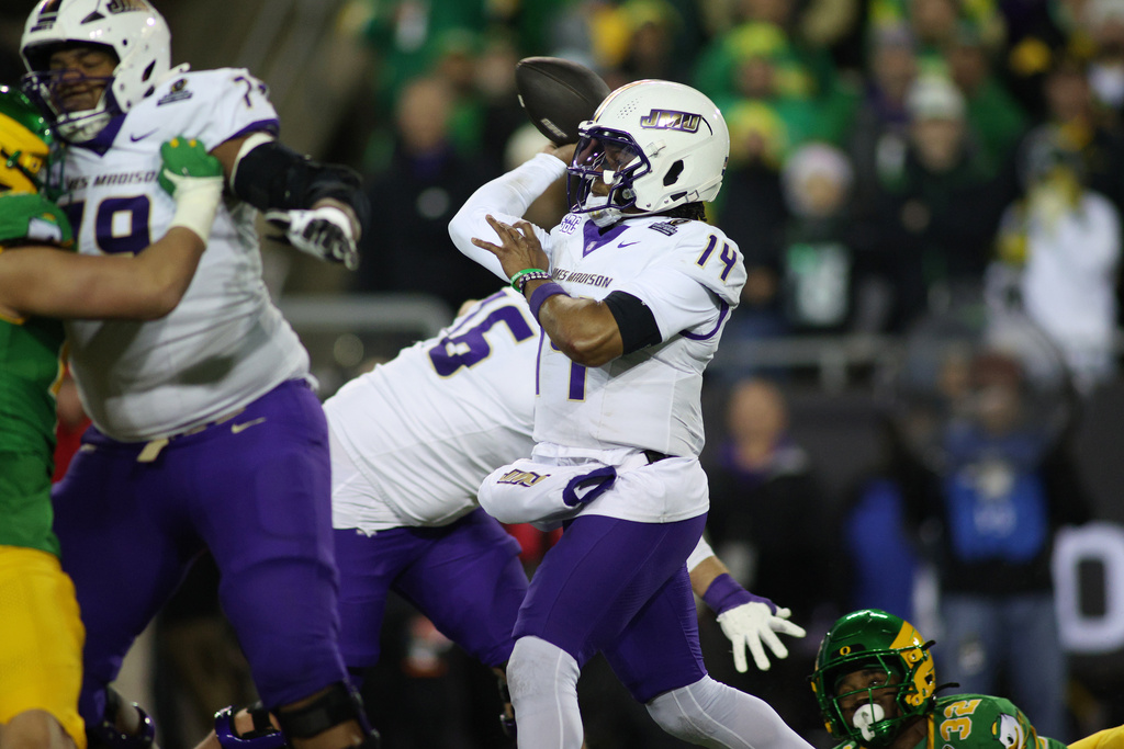 James Madison quarterback Alonza Barnett III (14) looks to pass the ball during the first half of the first round of the NCAA College Football Playoff against Oregon, Saturday, Dec. 20, 2025, in Eugene, Ore. (AP Photo/Lydia Ely)